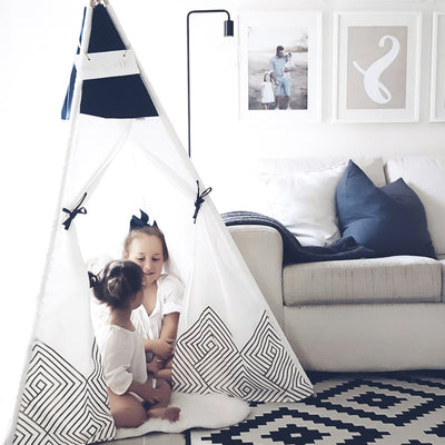 Kids playing and reading in their Cattywampus Gold Cloud Teepee tent on their birthday party